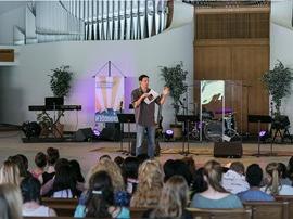 Campus pastor giving a sermon in chapel.